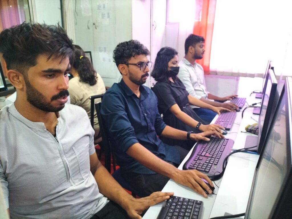 Students attending a digital marketing course in Calicut working on computers during a practical training session in a classroom environment.